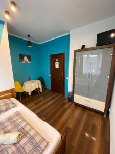 a room with two beds and a table in it at Hostel 1902 in Zakopane