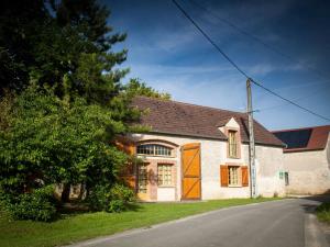 a white house with an orange door on a street at Maison de campagne rénovée à 1h de Paris, avec jardin clos, 4 chambres et équipements familiaux - FR-1-590-164 in Treilles-en-Gâtinais