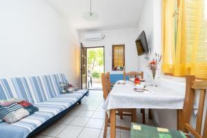 a living room with a couch and a table at Seaside holiday house Preko, Ugljan - 21106 in Poljana