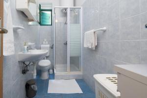a bathroom with a shower and a toilet and a sink at Seaside holiday house Preko, Ugljan - 21106 in Poljana +14 photos