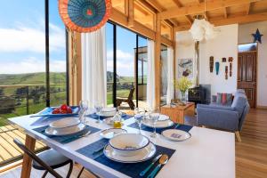 a dining room with a table with plates and glasses at Lodge Alas de Matanzas in Matanzas