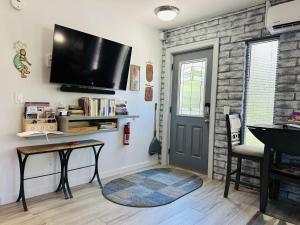 a living room with a flat screen tv on the wall at Artsy Casita, King Bed, Walk to Trails & Food, Mountain Views, Trail Pass in Sedona