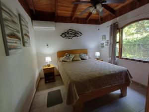 a bedroom with a bed and a ceiling fan at Gray House Domenico in Potrero