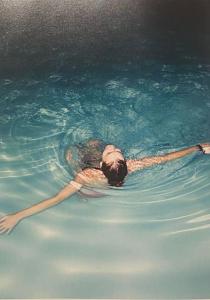 een persoon die zwemt in een zwembad van water bij Podere San Giorgio in Palaia