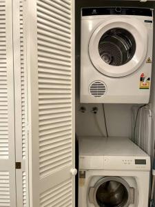a washing machine and a dryer in a room at Waterfront Sub-Penthouse with Beach View in Geelong