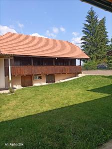 a building with a grass yard in front of it at Family friendly house with a swimming pool Mihalic Selo, Karlovac - 20284 in Duga Resa