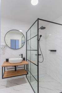 a bathroom with a sink and a mirror at Apartments & Rooms Klemenc in Cres