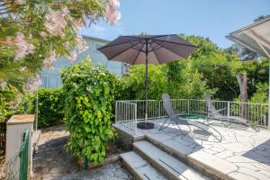 a patio with two chairs and an umbrella at Holiday house with a parking space Jadrija, Sibenik - 20641 in Šibenik +22 photos