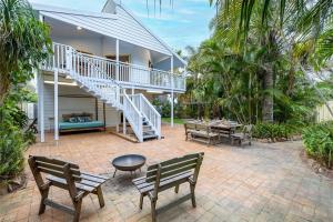 an outdoor patio with two benches and a staircase at The Birubi Beach House 11 Campbell Ave Close to the beach pet friendly holiday home in Anna Bay
