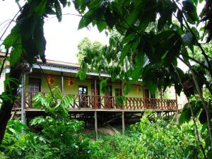 a house with a deck in the woods at The Last Frontier Boutique Resort in Bilit