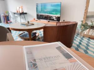 a magazine sitting on top of a wooden table at Maison Boheme - La Manzana Panama in Panama City