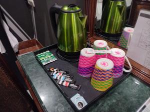 a table with two green coffee pots and yarn at Hotel Baco in Seville