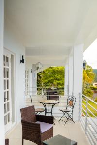 un patio con sillas y una mesa en un porche en Lavender Moon Villas, 