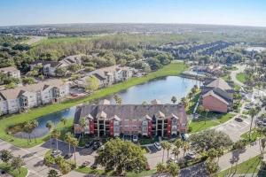 an aerial view of a town with a lake and houses at Cozy & spacious 2 BR / 2 BA condo in Kissimmee
