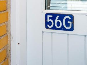 a blue and white sign on a door at 4 person holiday home in Sydals in Østerby