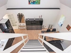 a living room with a staircase and a piano at Holiday home Ebeltoft CCXXII in Ebeltoft