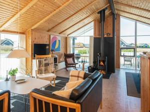 a living room with a couch and a fireplace at 9 person holiday home in Harboøre-By Traum in Harboør