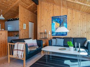 a living room with a couch and a table at 9 person holiday home in Harboøre-By Traum in Harboør
