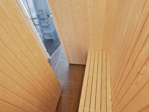 a wooden bench in a room with a wooden wall at Luxury Retreat in Kegnaes - By Traum Ferienwohnungen in Sønderby +42 photos