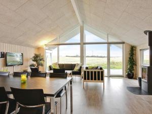 a living room with a couch and a table at Holiday home Sydals LXXXVI in Sønderby