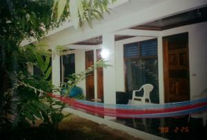 a house with a rainbow painted on the side of it at Hotel Sunshine in Cahuita