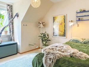 a bedroom with a green bed with a furry blanket on it at 4 person holiday home in Västervik in Västervik