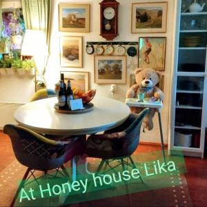 a teddy bear sitting on a table in a room at Honey house Lika in Gospić