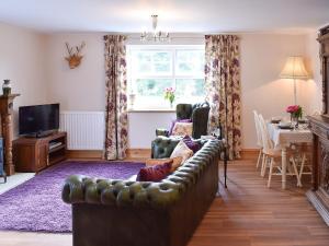 a living room with a couch and a table at Seventh Heaven in Bagby