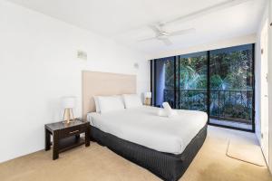 a bedroom with a bed and a large window at The Rocks Resort Unit 3C in Gold Coast