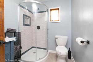 a bathroom with a toilet and a glass shower at Inn Between-Asheville/Waynesville in Canton +9 photos