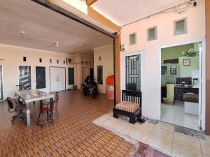 a large room with a table and chairs in it at RedDoorz Syariah near Pasar Raya Padang in Padang