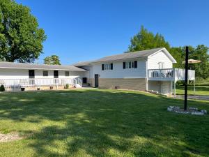 a large white house with a large yard at Hotel Marceline in Marceline