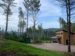 un bâtiment au milieu d'un champ arboré dans l'établissement Vallée bras du Nord Jumeau 2 avec spa, à Saint-Raymond