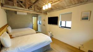 Llit o llits en una habitació de Island Flower Inn
