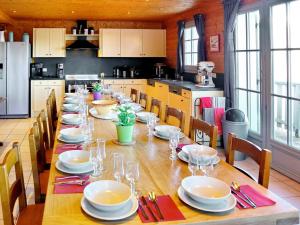 a long table in a kitchen with plates and wine glasses at Chalet Le Corbier, 8 pièces, 16 personnes - FR-1-267-257 in Villarembert