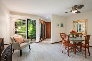 a living room with a table and chairs at Waikomo Streams 203 in Koloa