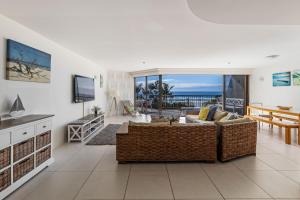a living room with a couch and a table and a television at The Rocks Resort Unit 3C in Gold Coast