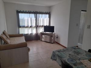 a living room with a couch and a television at Dpto Piacentini in Resistencia