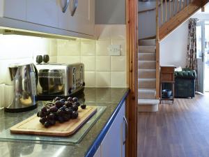 a kitchen with a cutting board with grapes on a counter at Seventh Heaven in Bagby