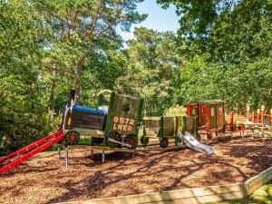 a small playground with a train and a slide at Robins Retreat in Weybourne