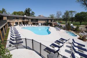 a large swimming pool with lounge chairs and a resort at Lake Lawn Resort in Delavan