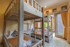 a bedroom with two bunk beds in a house at Alam Pracetha Bali Ubud in Ubud