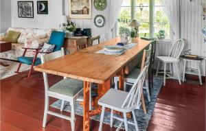 a dining room with a wooden table and chairs at Lovely Home In Lundamo With Kitchen 