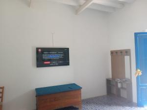 a room with a tv on the wall at Casa Galletta in Stromboli