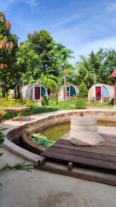 a group of campgrounds with tents in the background at The Bear Bungalow in Kampot