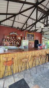 a bar with chairs and a counter in a restaurant at The Bear Bungalow in Kampot
