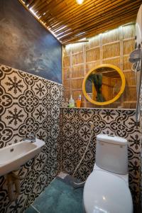 a bathroom with a toilet and a sink and a mirror at Cocohut Hoi An Homestay in Hoi An