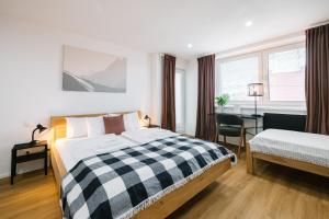 a hotel room with a bed and a desk and window at Serenity in Pribylina