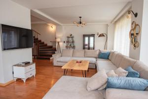 a living room with a couch and a table at Lux House with own parking in Skopje in Skopje