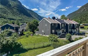 a row of houses with mountains in the background at 2 Bedroom Amazing Apartment In Rjukan in Rjukan